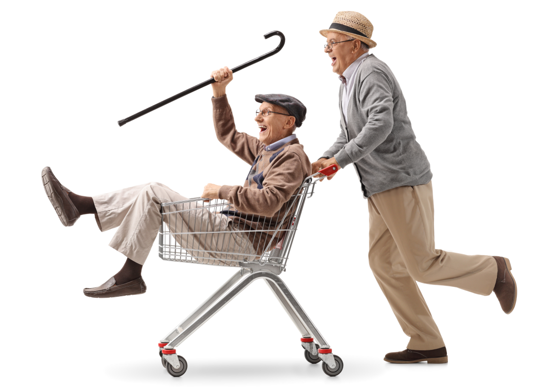 Two Senior citizens happily playing with a grocery cart