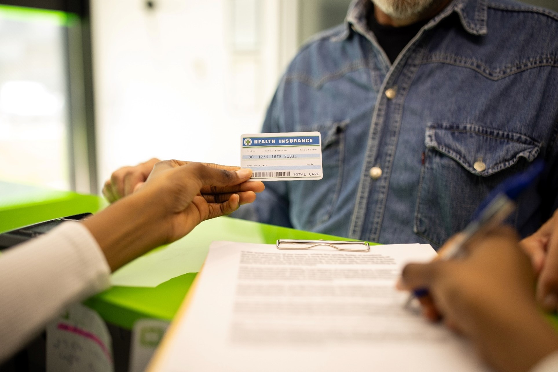 Nurse holding medical insurance card in the U.S.